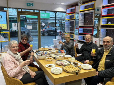 Blackheath eyecare community members saying cheers at the christmas social event