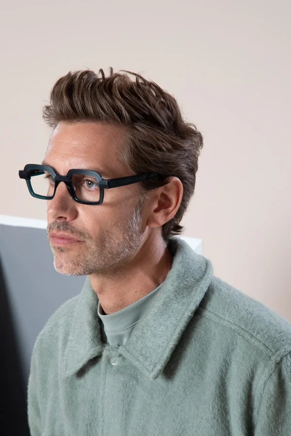 Man wearing rectangular black Anne et Valentin optical frames in portrait